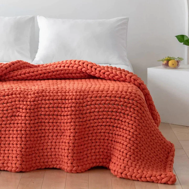 Zonli Orange Chunky Weighted Blanket Draped on Bed